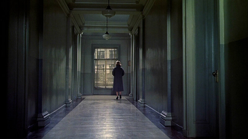 woman walking down hallway