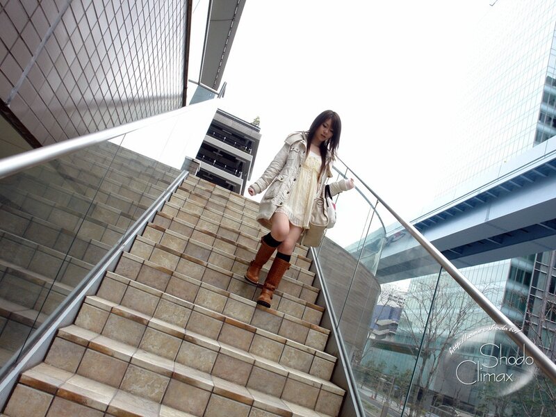 Woman walking down stairs in city