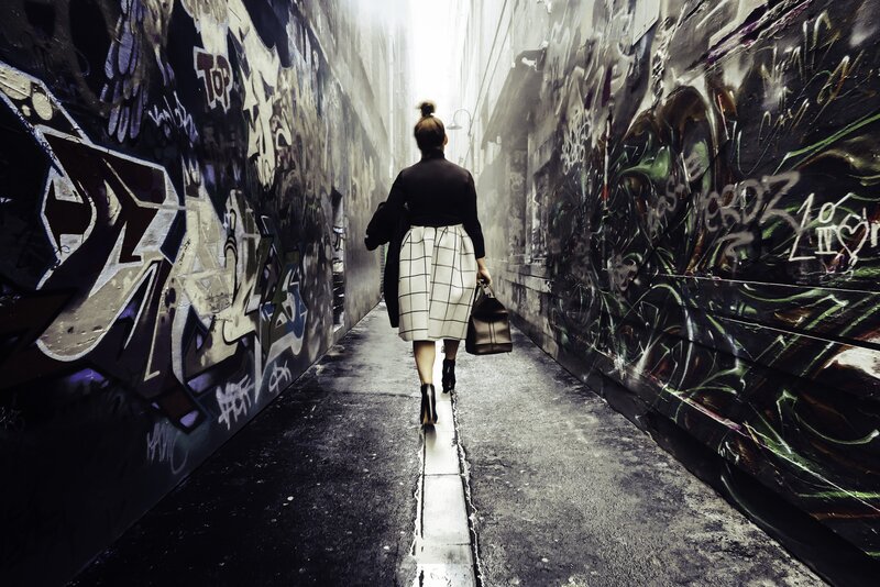 Woman Walking in Alley