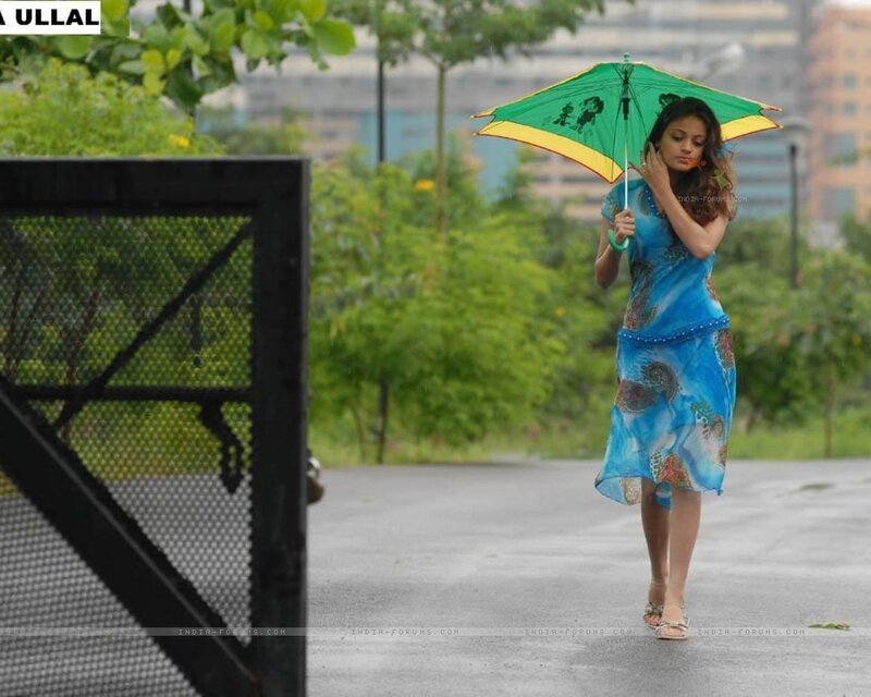 woman walking in rain with umbrella