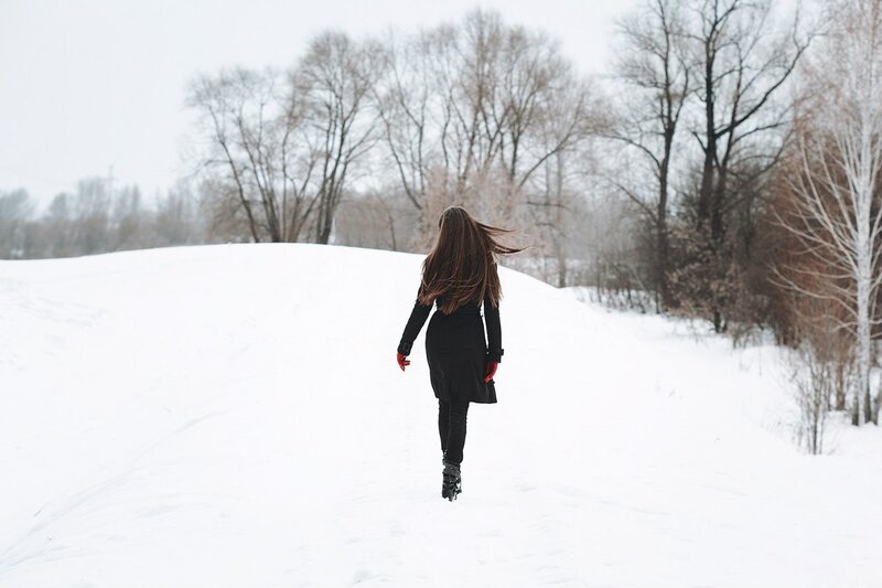 Woman Walking in Snow — White, Serene, Winter