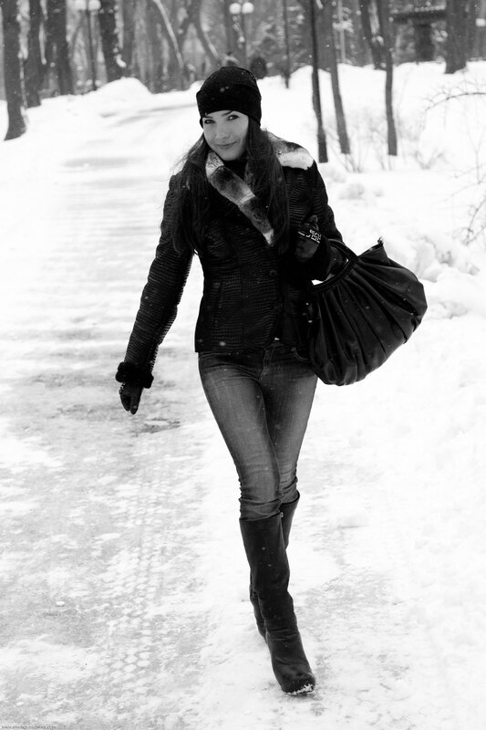 Woman walking in snowy park