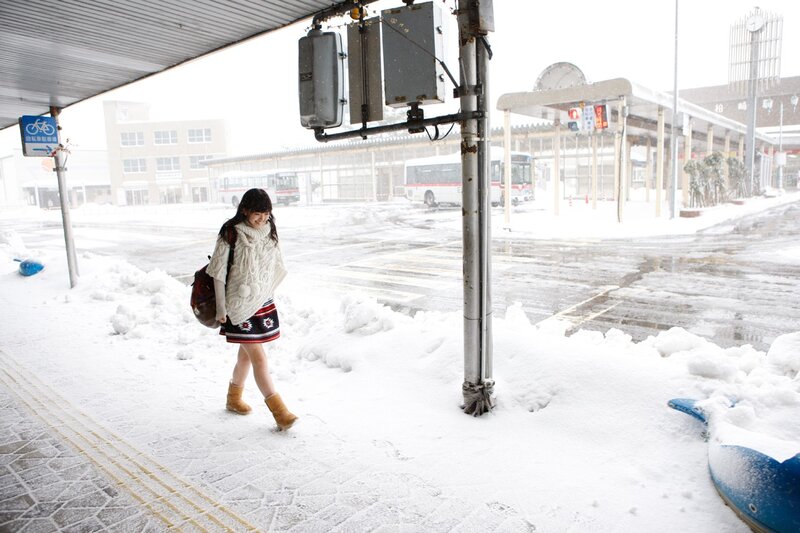 Woman walking in snowy station