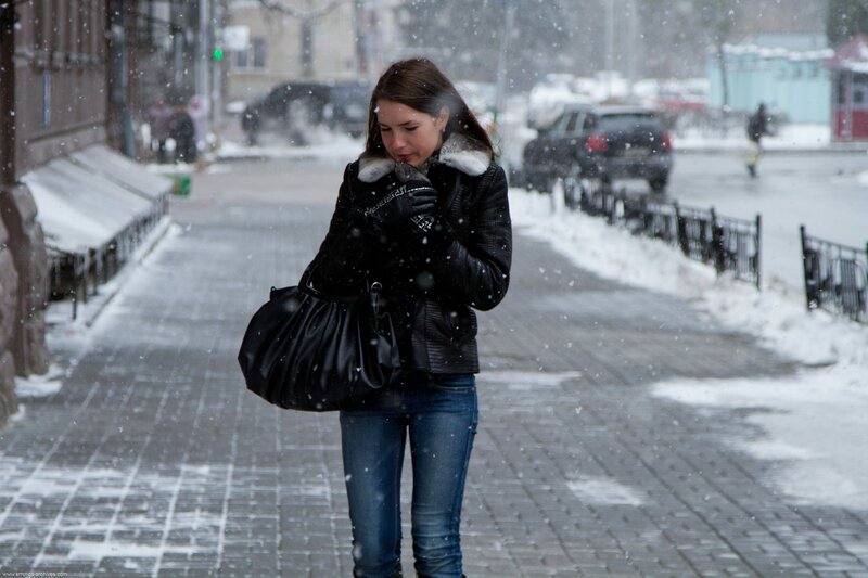 Woman walking in snowy street