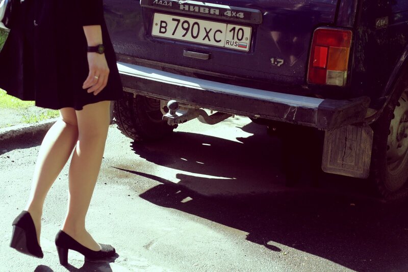 woman walking near car