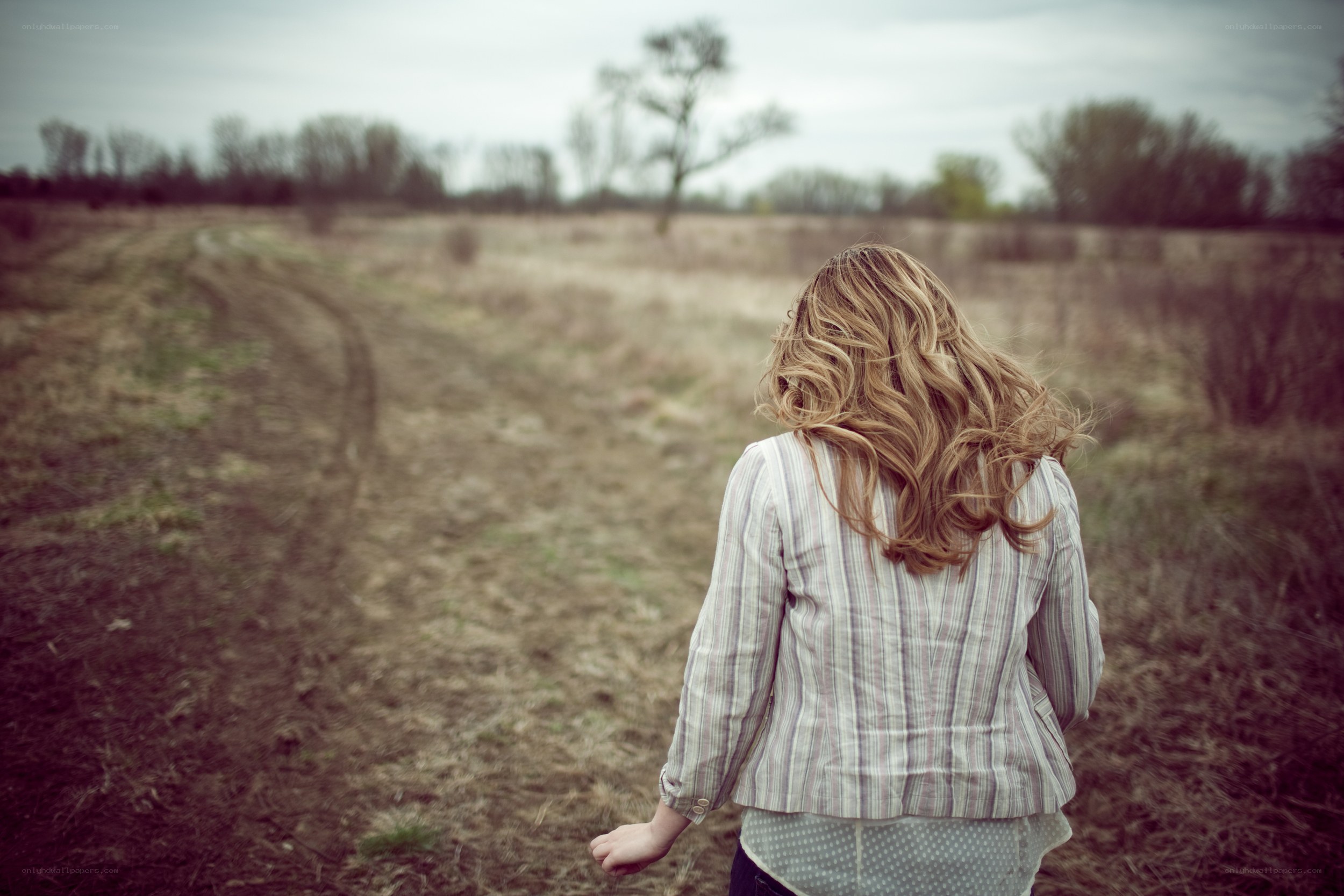 woman walking on a dirt path