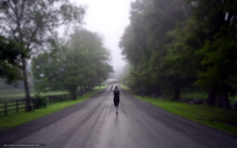 woman walking on a foggy road