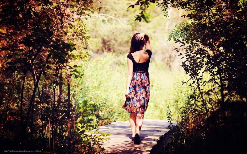 Woman walking on a forest path