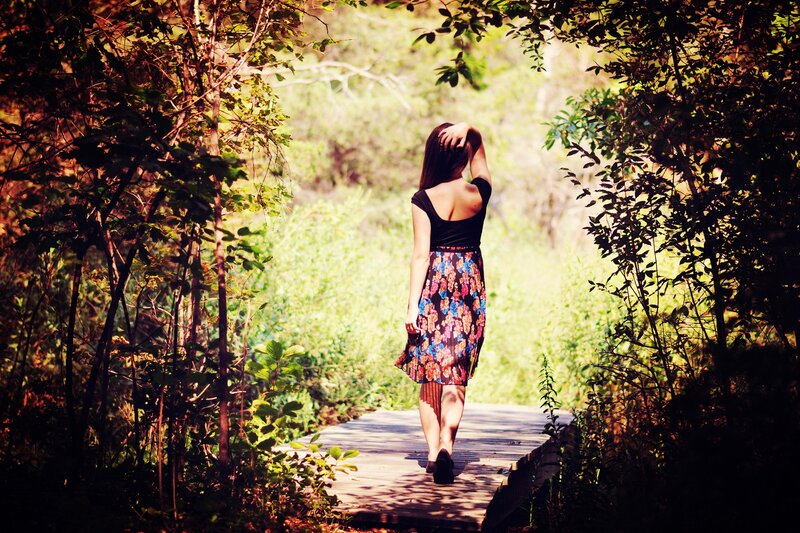 Woman walking on a forest path