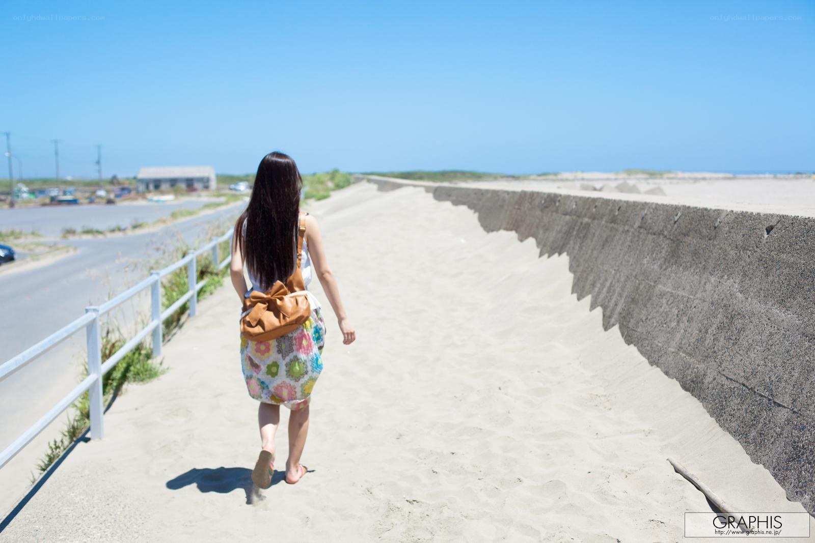 Woman walking on a sandy path