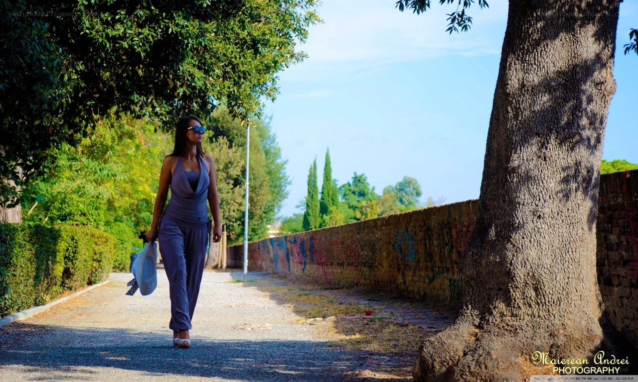 Woman walking on a sunny path