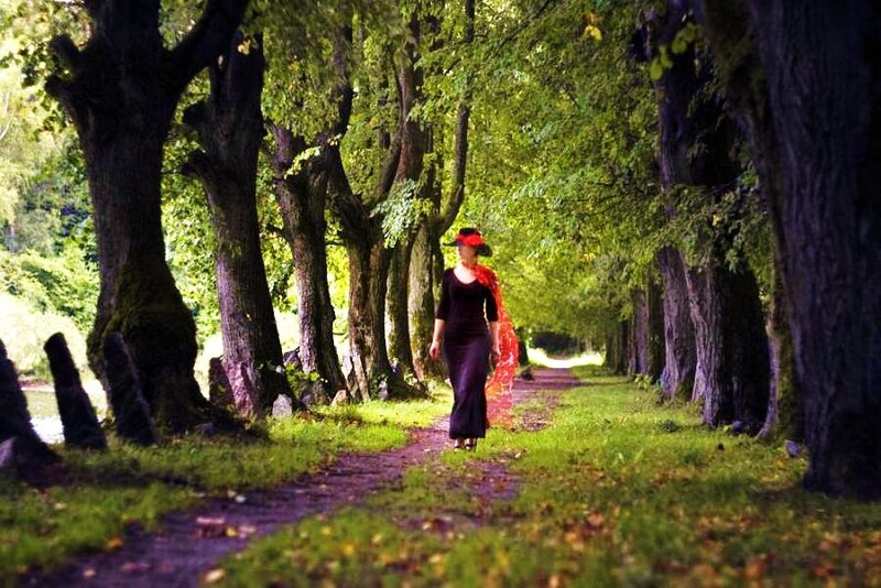 Woman walking on a tree-lined path