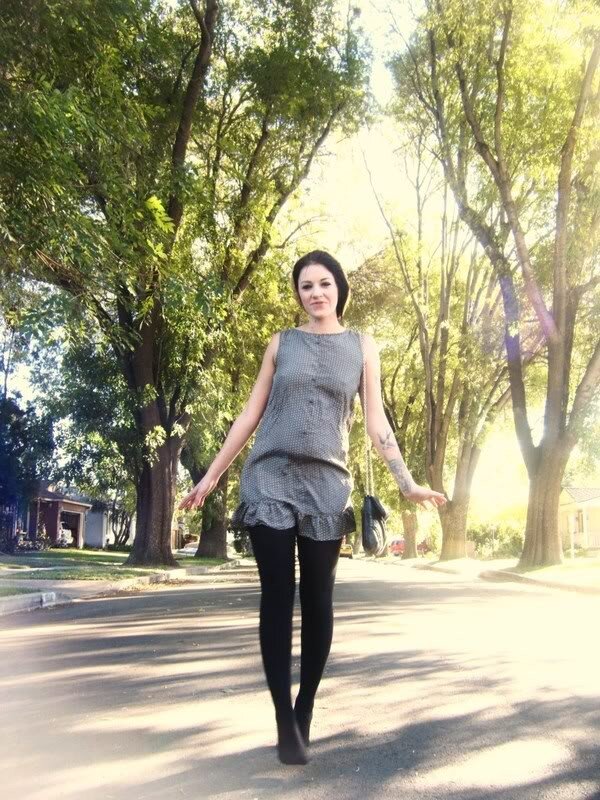 woman walking on a tree-lined street