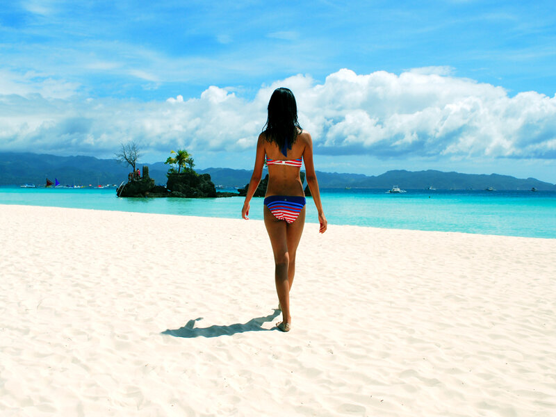 Woman walking on a tropical beach