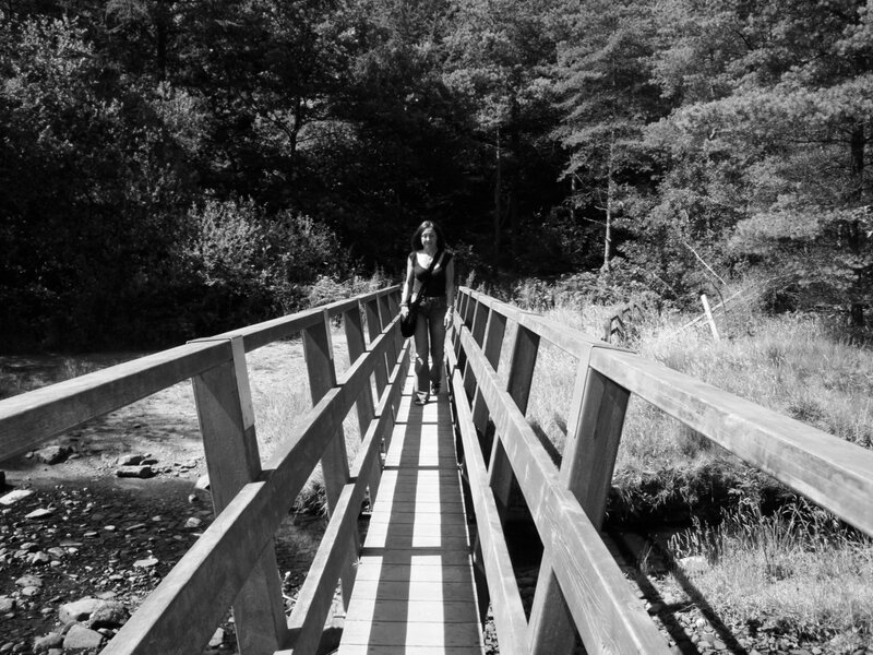 Woman walking on a wooden bridge