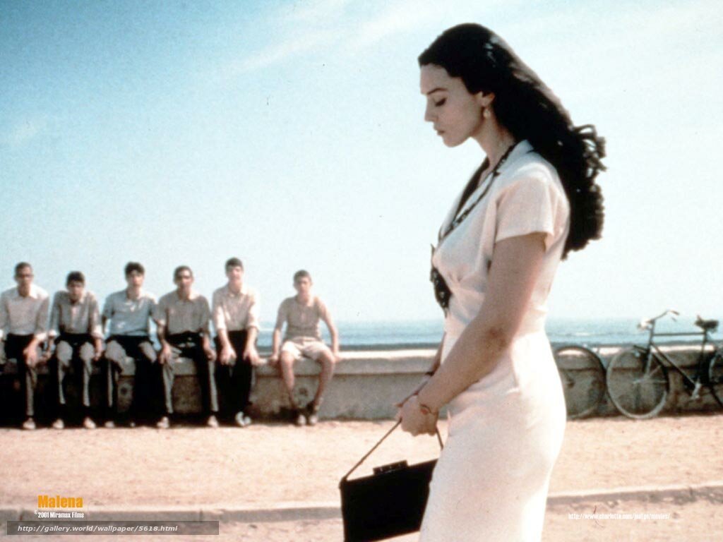 Woman walking on beach with boys