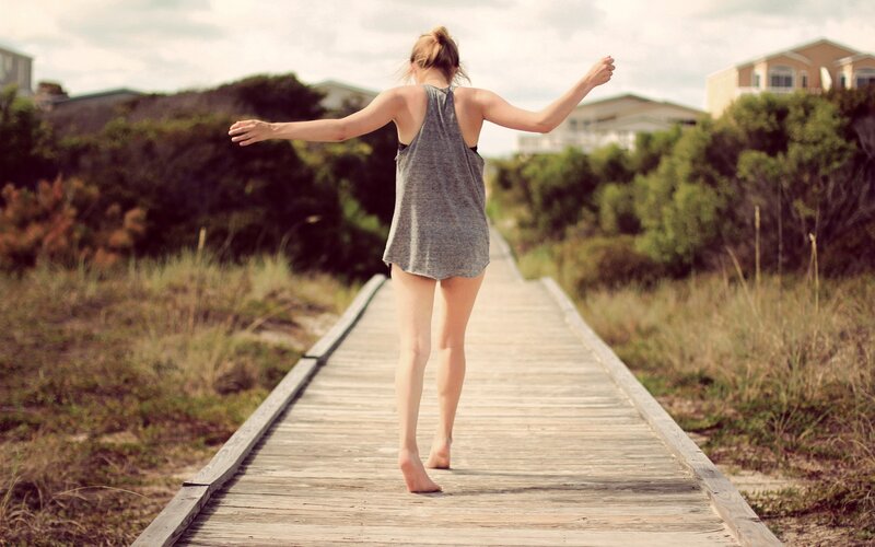 Woman walking on boardwalk
