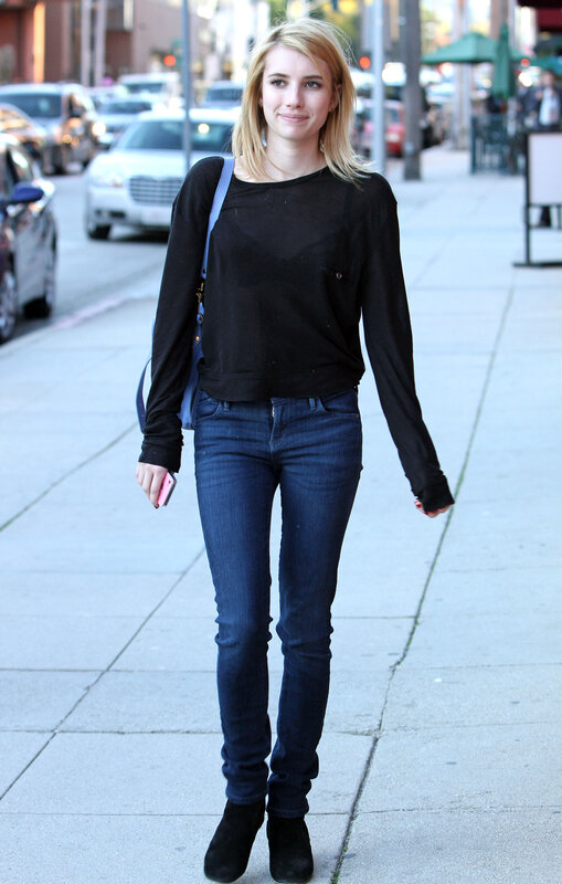 Woman walking on city sidewalk