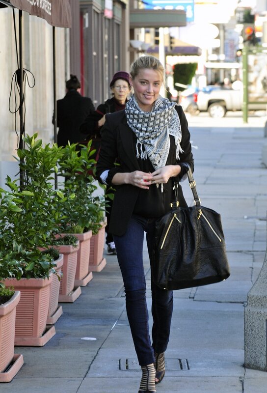 Woman walking on city sidewalk