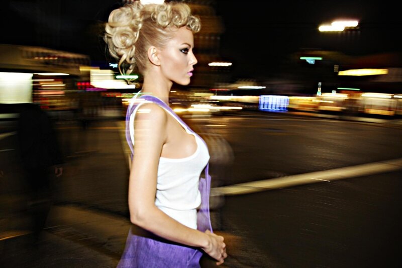 woman walking on city street at night