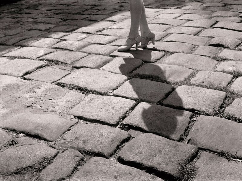 woman walking on cobblestones