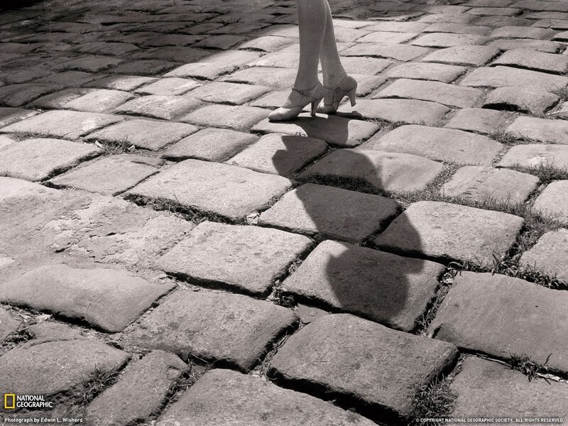woman walking on cobblestones