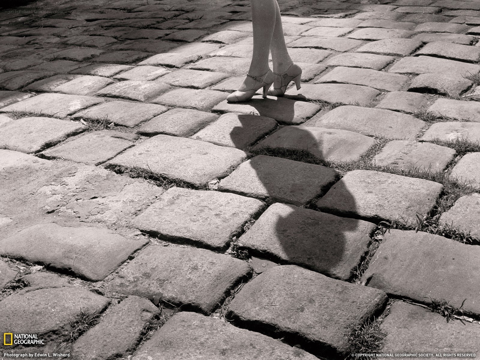 woman walking on cobblestones