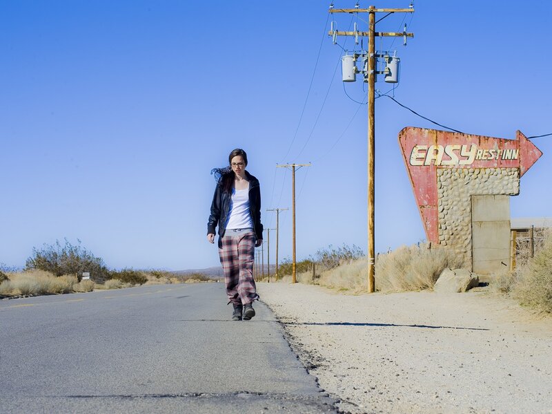 woman walking on desert road