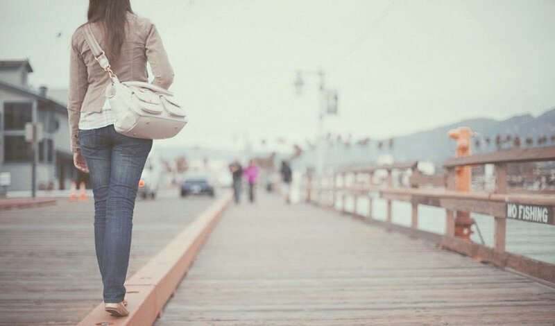 Woman Walking on Pier — Brown