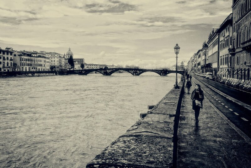 Woman Walking on Riverbank