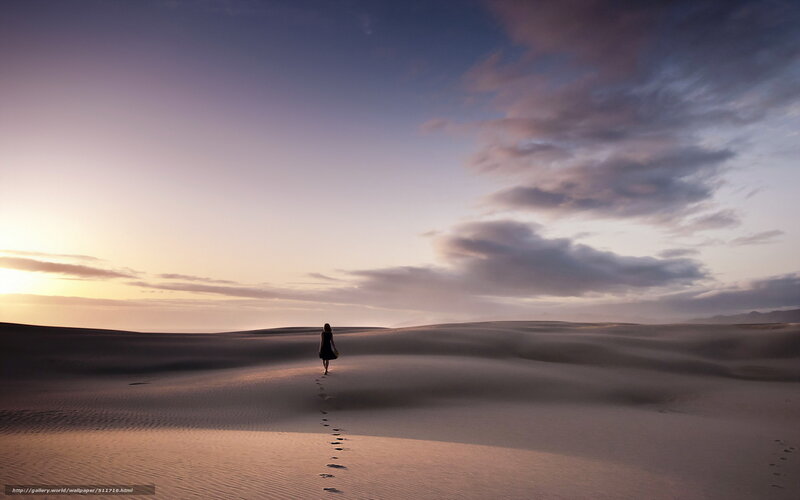 woman walking on sand dunes