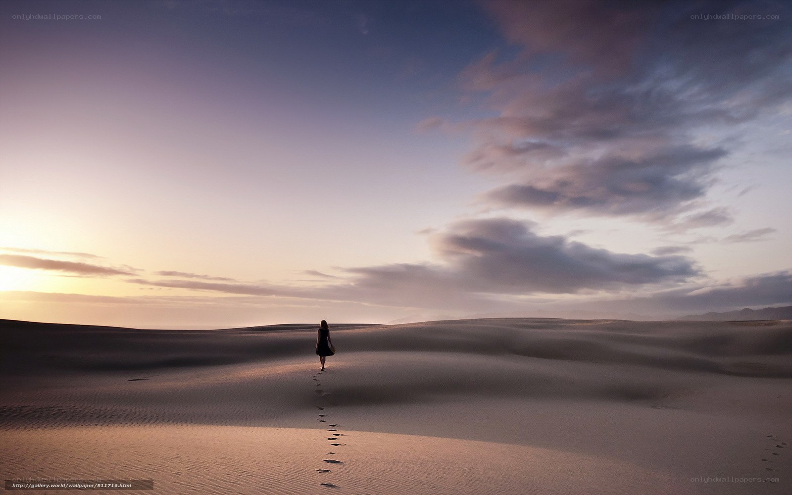 woman walking on sand dunes