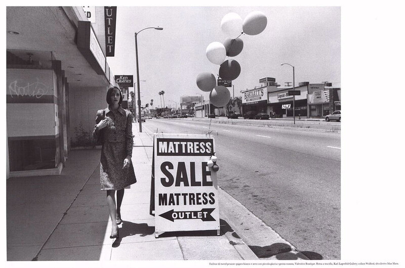 Woman walking on sidewalk with balloons