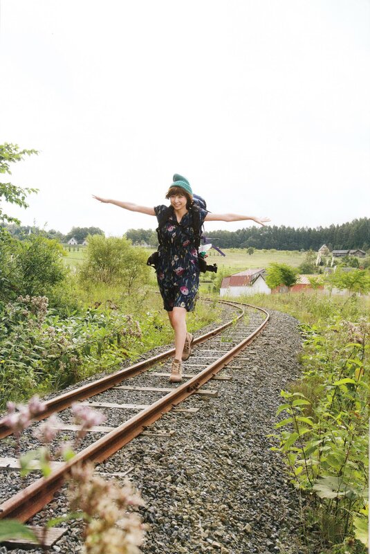Woman walking on train tracks