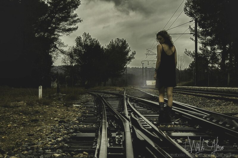 woman walking on train tracks