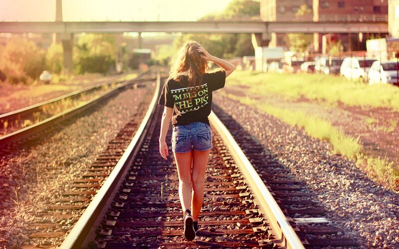 Woman Walking on Train Tracks — Brown, Serene