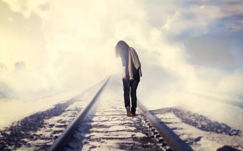 woman walking on train tracks