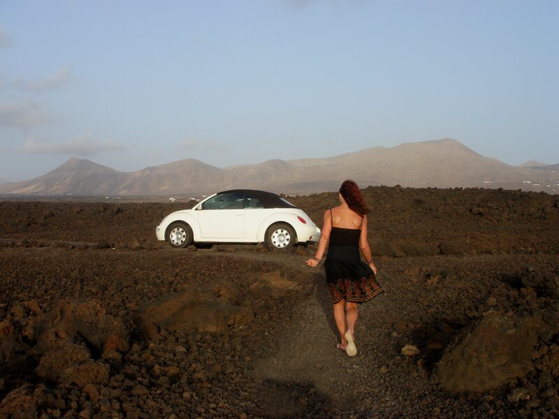 Woman walking on volcanic terrain