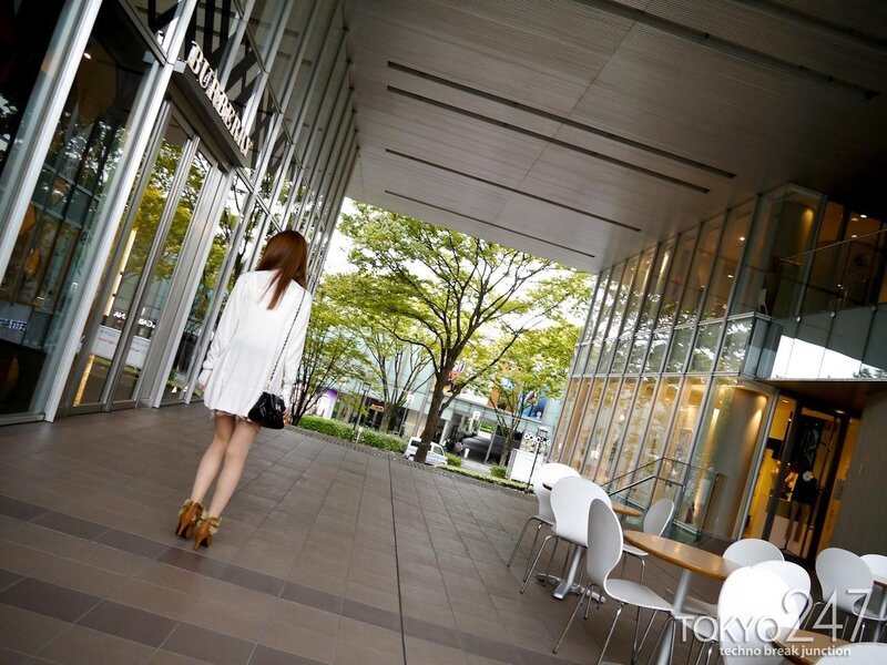 Woman walking outside a shopping center