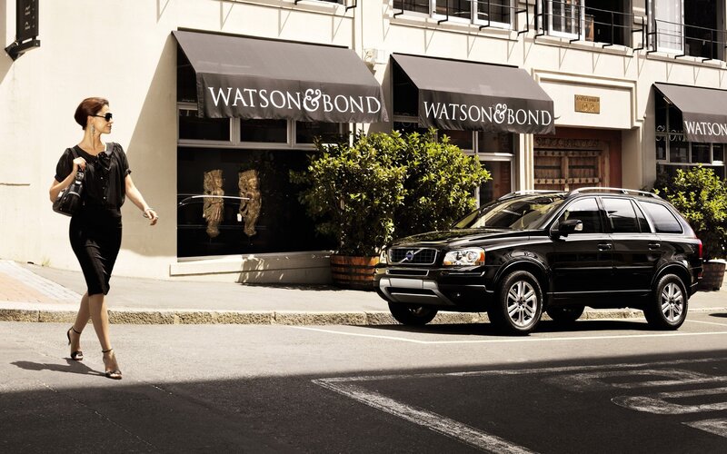 Woman walking past a Volvo SUV