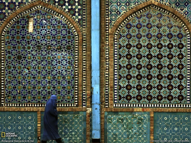 woman walking past tiled arches
