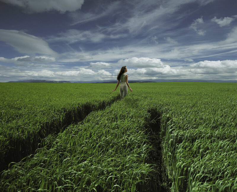 Woman walking through a green field