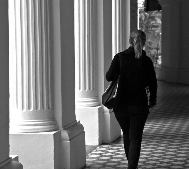 woman walking through colonnade
