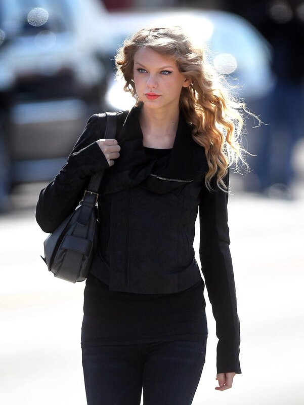 woman walking with black bag