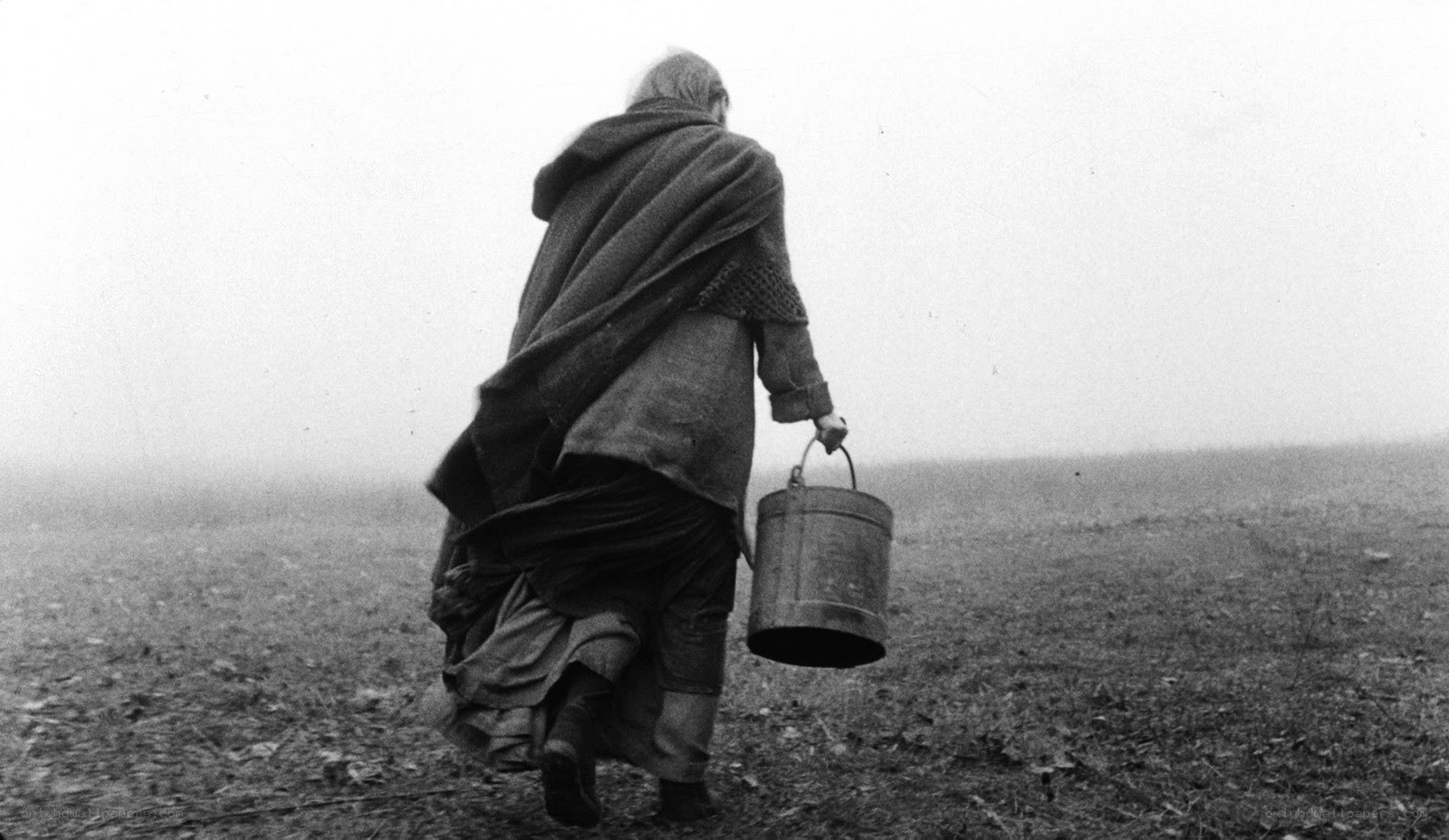 Woman walking with bucket