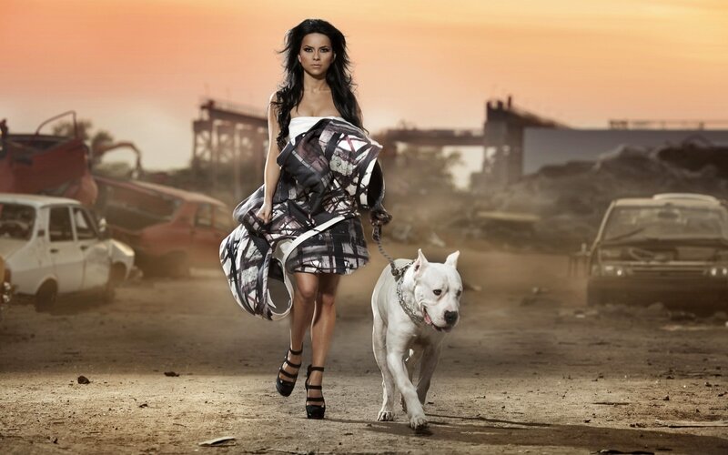 woman walking with dog in junkyard