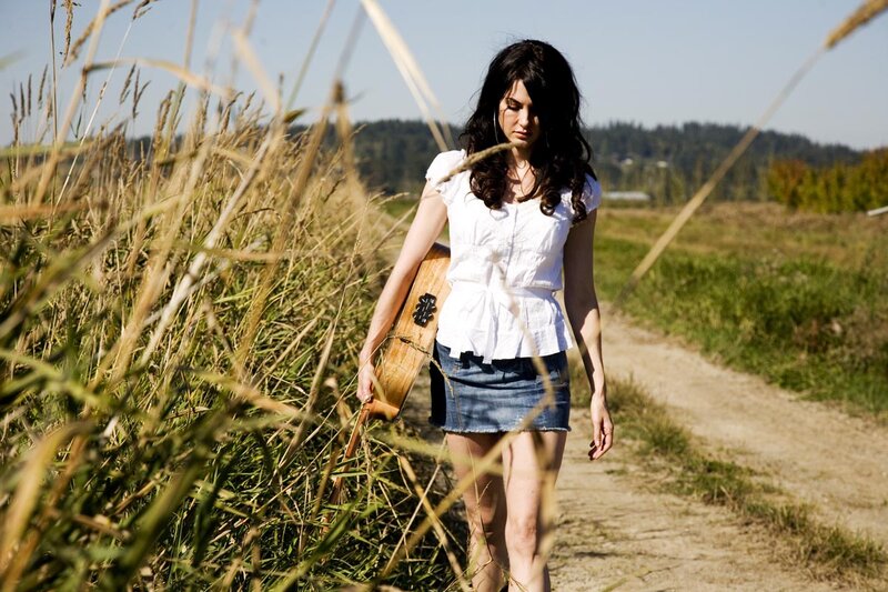 Woman Walking with Guitar