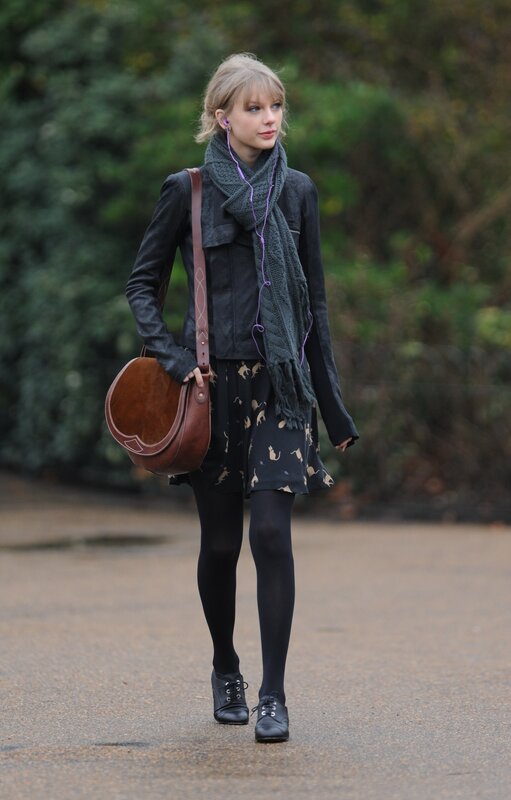 woman walking with scarf and bag