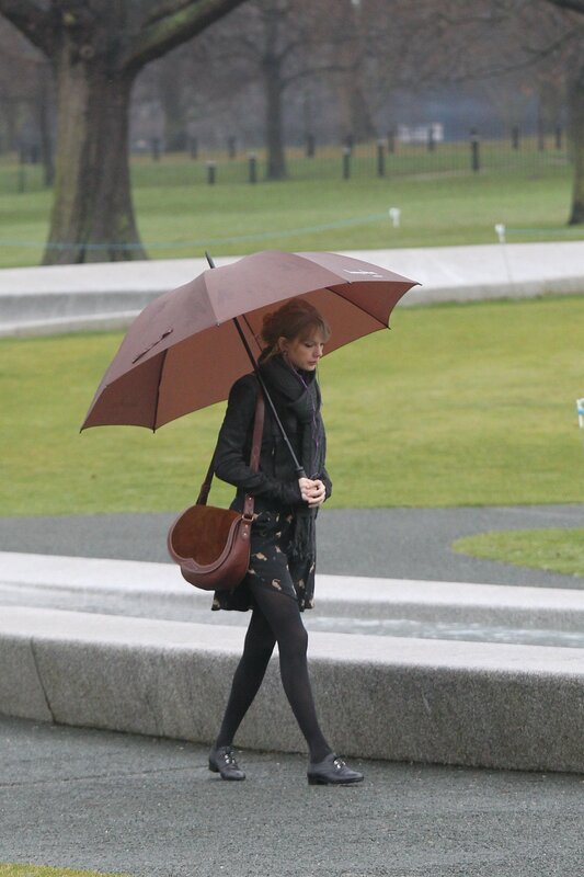 Woman walking with umbrella in park