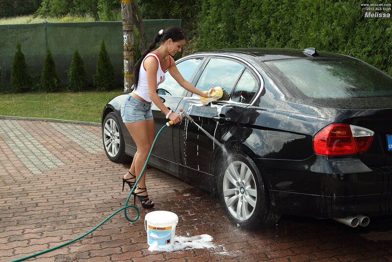 Woman washing a black car